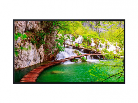 Wooden footbridge over emerald water leading to waterfalls in lush green forest—nature landscape photo.