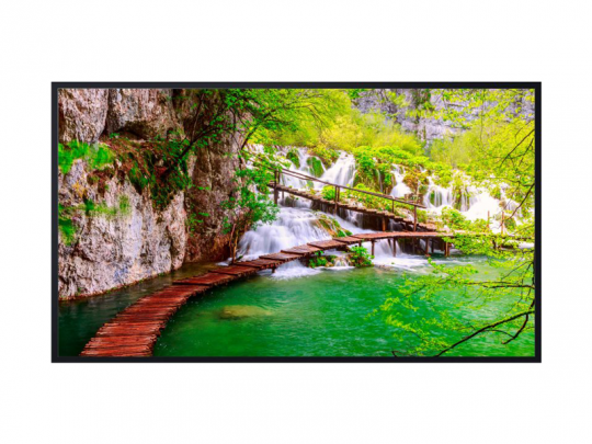 Curved wooden footbridge over emerald-green water with small waterfalls, lush green foliage, and rocky cliffs; scenic landscape ideal for nature travel and hiking.
