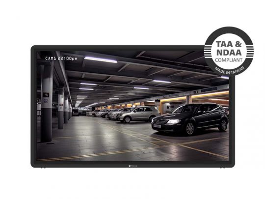 Surveillance monitor displaying live footage of a brightly lit indoor parking garage with multiple parked cars; on-screen badge reads TAA & NDAA Compliant, Made in Taiwan indicating security camera system compliance and origin.